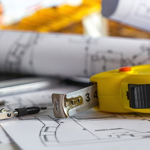 Tape measure and blueprints