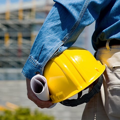 Worker holding hard hat