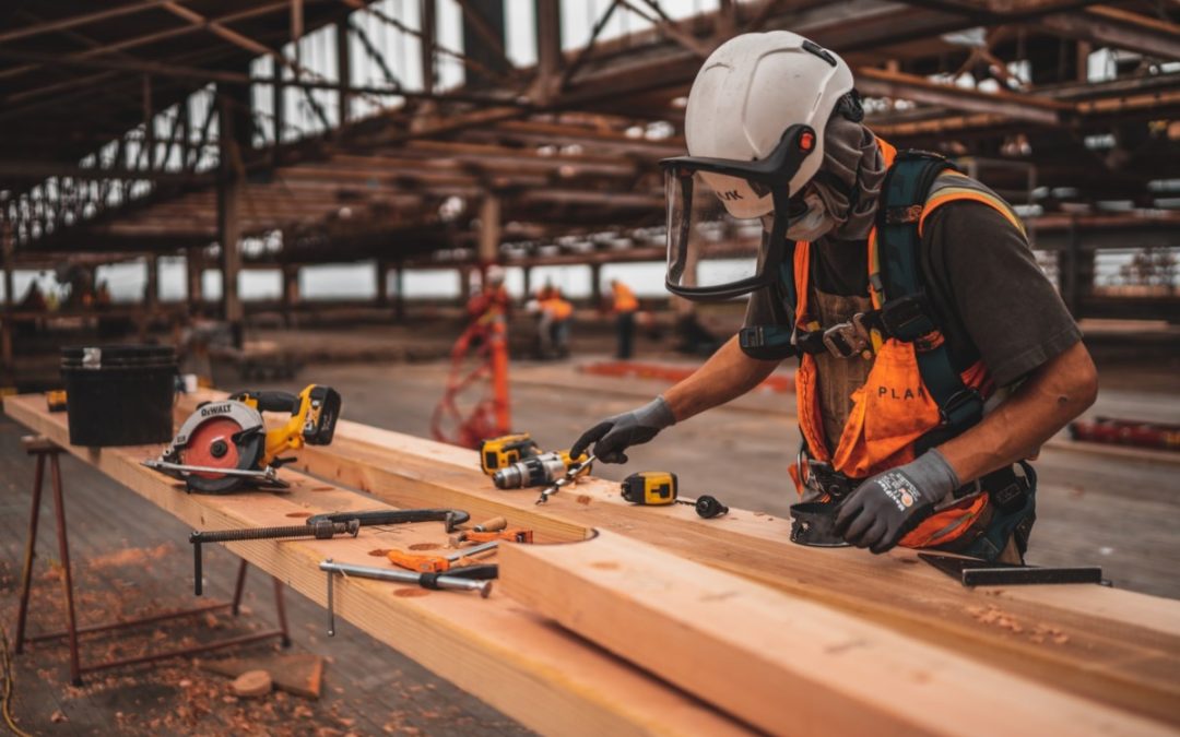 Construction worker using tools at job site 